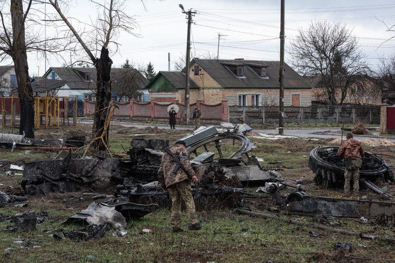 Ukrainian servicemen inspect the remains of a Russian tank by the road on April 8, 2022 in Zdvyzhivka, Ukraine.