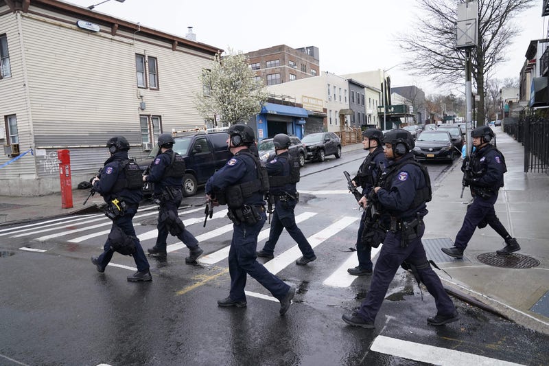 Members of the New York Police Department patrol the streets after 16 people were injured during a rush-hour shooting at a subway station in the New York borough of Brooklyn on April 12, 2022, where authorities said "several undetonated devices" were recovered amid chaotic scenes.