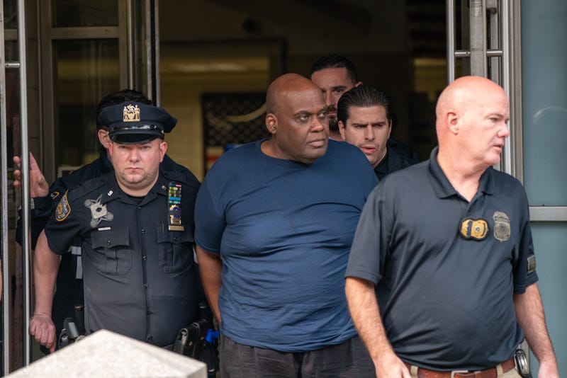 Suspect Frank James is escorted out of the 9th Precinct by police after being arrested in the East Village on April 13, 2022