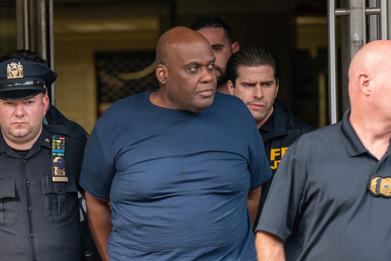 Suspect Frank James is escorted out of the 9th Precinct by police on April 13, 2022