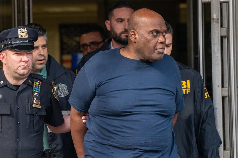 Suspect Frank James is escorted out of the 9th Precinct by police after being arrested in the East Village on April 13, 2022