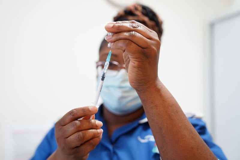 A nurse prepares a dose of a Covid-19 vaccine for Margaret Keenan, 91, prior to her receiving a spring Covid-19 booster shot at University Hospital Coventry on April 22, 2022 in Coventry, England. 