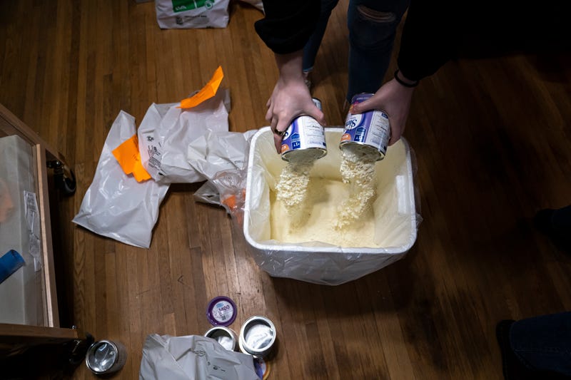 Katie Wussler, a program coordinator at Mother & Child Education Center, throws away recalled Similac baby formula, which the company would not replace or reimburse because the donated supplies did not come with a receipt, on May 12, 2022 in Portland, Oregon. More than 60 percent of Mother & Childs formula supply was affected by the recall, and like many similar non-profits they are struggling to meet increased demand from mothers who are unable to find or afford formula in stores. Executive Director Maura White said she's had to turn away mothers looking for formula about three times a week since the recall was announced.