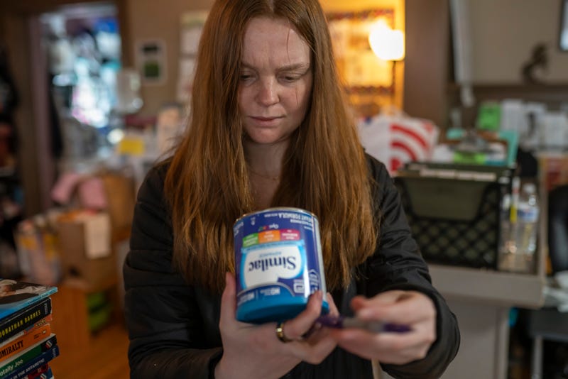 Katie Wussler, a program coordinator at Mother & Child Education Center, checks the lot number on a donated can of Similac baby formula against a list of recalled cans on May 12, 2022 in Portland, Oregon. More than 60 percent of Mother & Childs formula supply was affected by the recall, and like many similar non-profits they are struggling to meet increased demand from mothers who are unable to find or afford formula in stores. Executive Director Maura White said she's had to turn away mothers looking for formula about three times a week since the recall was announced.