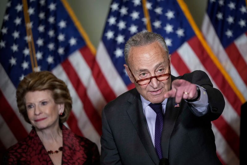 Senate Majority Leader Chuck Schumer (D-NY) speaks to reporters following a closed-door lunch with Senate Democrats at the U.S. Capitol on May 18, 2022 in Washington, DC. Schumer spoke on a range of topics, including reintroducing an updated version of a domestic terrorism bill in the wake of the shooting in Buffalo, New York. Also pictured at left is Sen. Debbie Stabenow (D-MI). (Photo by Drew Angerer/Getty Images)