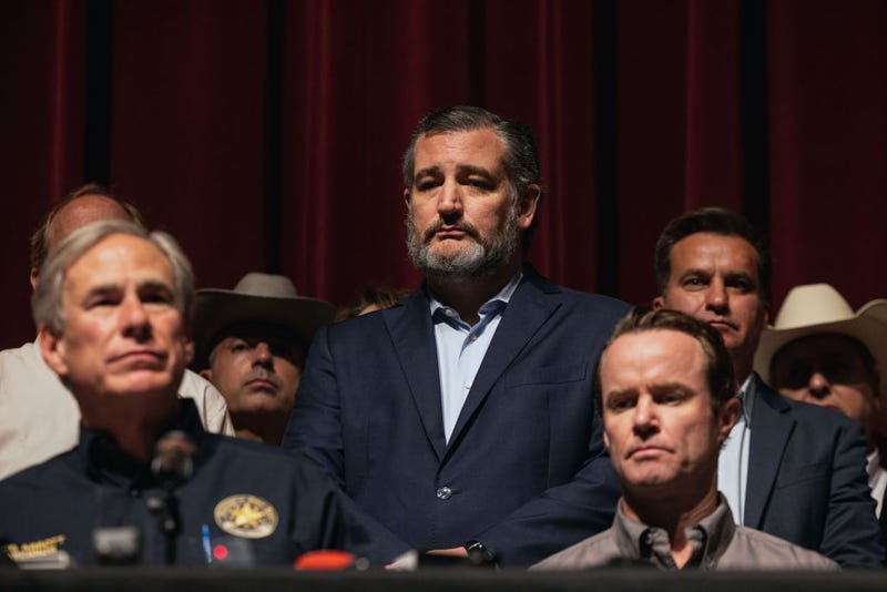Sen. Ted Cruz (R-TX) looks on as Texas Gov. Greg Abbott speaks during a press conference at Uvalde High School on May 25, 2022 in Uvalde, Texas. On May 24, 21 people were killed, including 19 children, during a mass shooting at Robb Elementary School. The shooter, identified as 18-year-old Salvador Ramos, was reportedly killed by law enforcement. (Photo by Jordan Vonderhaar/Getty Images)