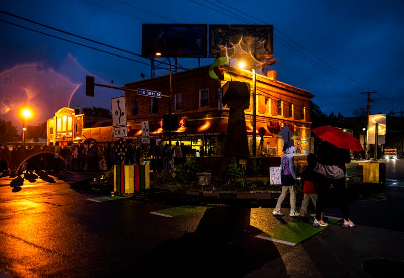 People walk through George Floyd Square during a vigil for George Floyd on May 25, 2022 in Minneapolis, Minnesota, two years after Floyd was murdered by Minneapolis Police Officer Derek Chauvin at the site. Now the city is continuing its discussions with those who live and work in the area about how to re-design the intersection.
