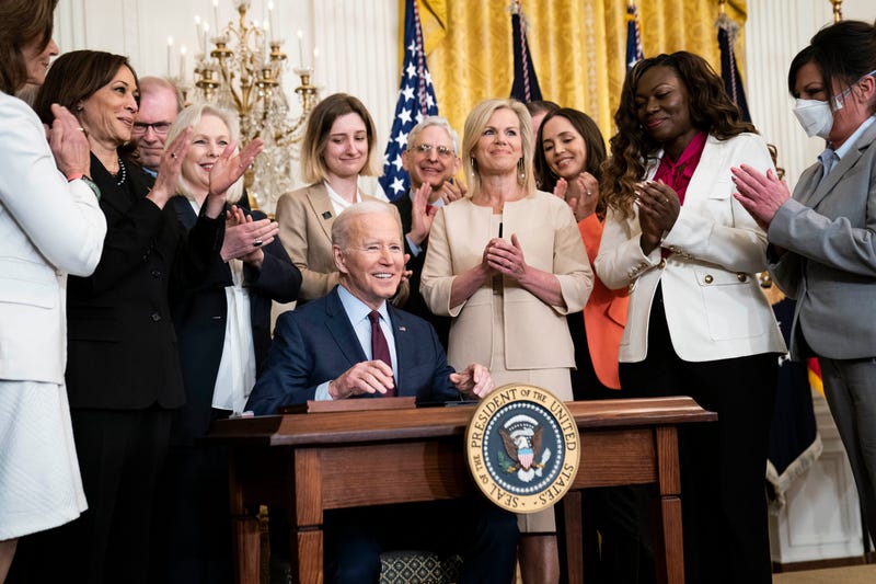 President Joe R. Biden, surrounded by members of congress and survivors of sexual assault including Gretchen Carlson, smiles after signing H.R. 4445, legislation to end force arbitration on sexual assault and harassment claims, in the East Room at the White House on Thursday, March 3, 2022 in Washington, DC.