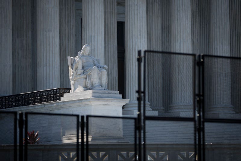 A view of the U.S. Supreme Court through security fencing on June 1, 2022 in Washington, DC. The country continues to wait for an official decision in the Dobbs v. Jackson Womens Health Organization case that could essentially overturn the landmark Roe v. Wade abortion decision. According to media reports, Supreme Court officials are escalating their search for the source of the leaked draft opinion in the case. The justices have 33 remaining cases to be decided by the end of June or the first week in July. The issues include abortion, guns, religion and climate change. (Photo by Drew Angerer/Getty Images)
