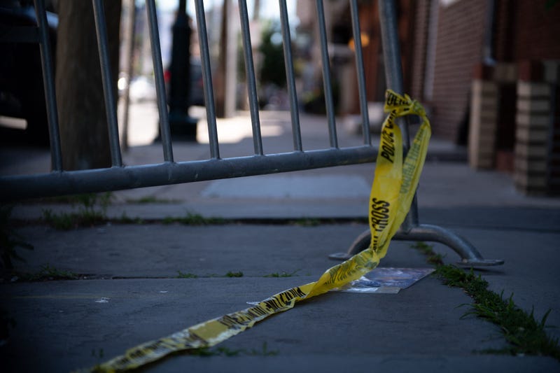 Police tape hangs from a barricade at the corner of Lombard and 4th streets in Philadelphia, on June 5, 2022