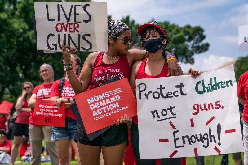 Raquel Gabin (L) hugs her mother Joseline Castanos while listening to speakers during the Moms Demand Action Gun Violence Rally on June 8, 2022 in Washington, DC. Politicians and activists continued their push for additional gun safety legislation following a series of deadly mass shootings in the U.S. (Photo by Nathan Howard/Getty Images)
