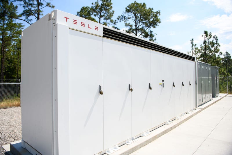 A 2-MW/2 megawatt-hour battery energy storage system made by Tesla is seen at Camp Mackall near Big Muddy Lake while the U.S. Army hosts a ribbon-cutting event to unveil a floating solar energy system on June 10, 2022 at Camp Mackall in Aberdeen, North Carolina.