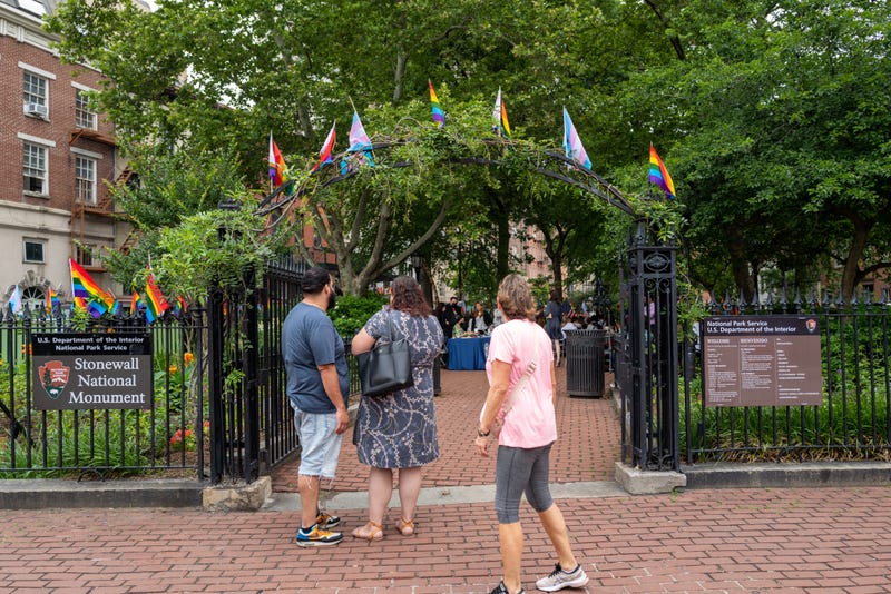 People walk by the Stonewall National Monument within Christopher Park in Greenwich Village during Pride Month
