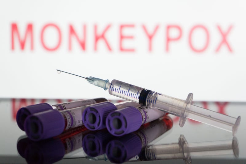 In this photo illustration, blood test vials and a syringe are seen in front of a screen that says ''Monkeypox''