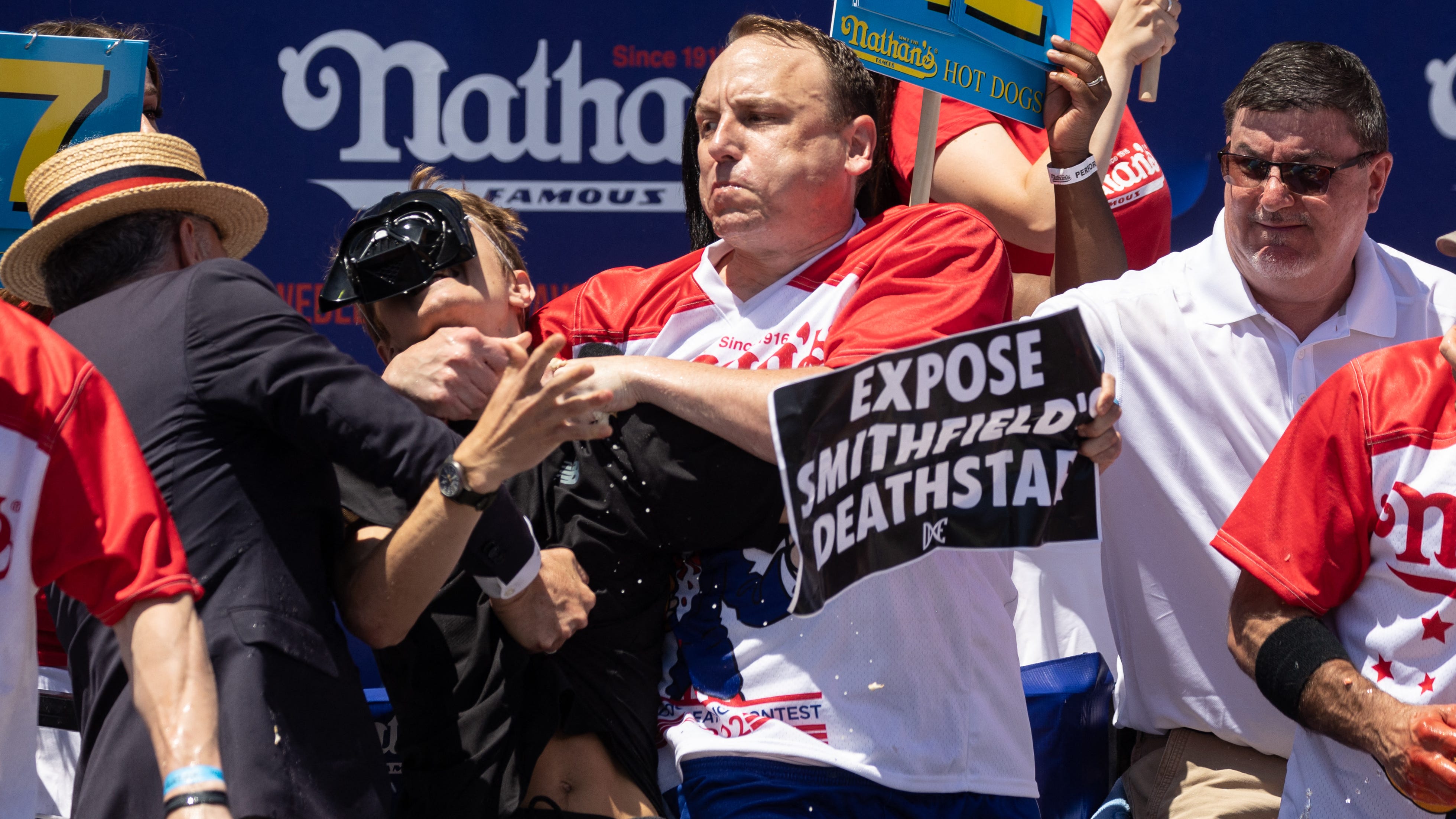 VIDEO & PICS: Joey Chestnut puts protester in headlock during Nathan's eating contest