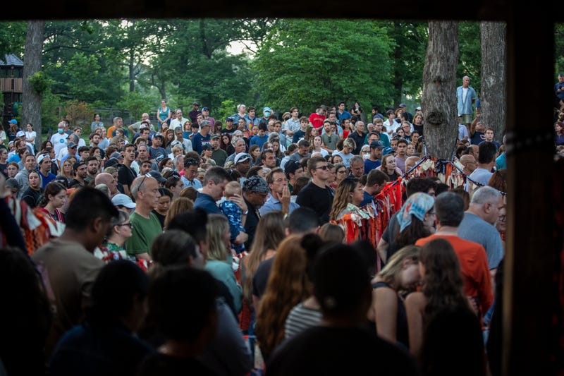 Highland Park community gathers at local park for vigil at sunset.
