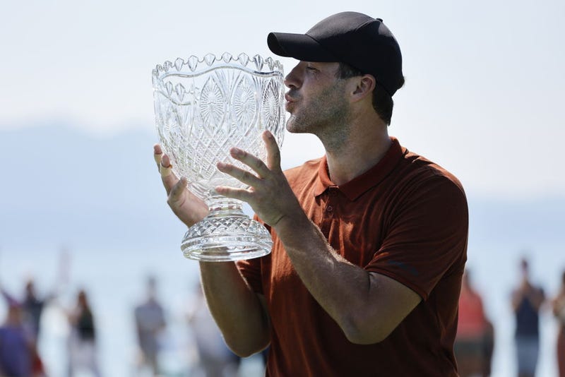 Former NFL quarterback Tony Romo kisses the trophy after winning the American Century Championship at Edgewood Tahoe Golf Course on July 10, 2022 in Stateline, Nevada.