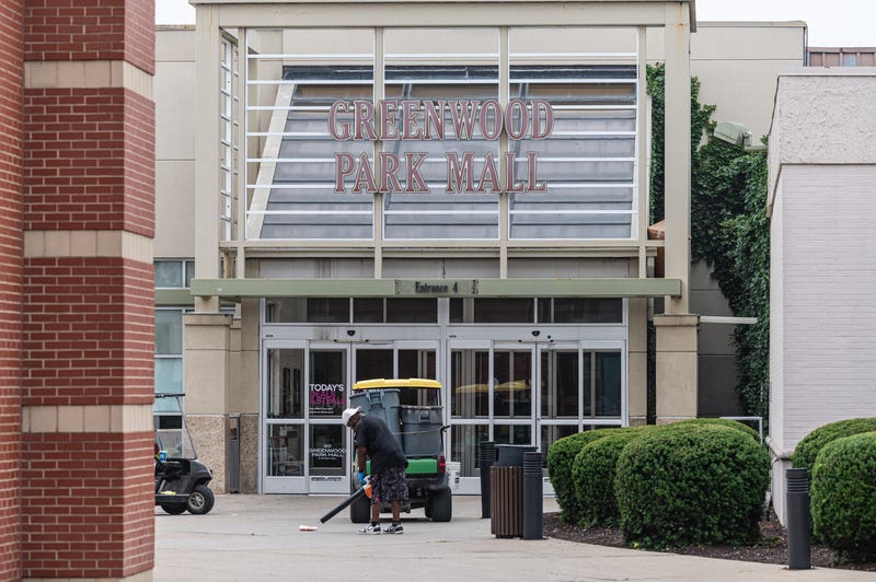 A mall employee works outside of the food court entrance to Greenwood Park Mall on July 18, 2022 in Greenwood, Indiana.