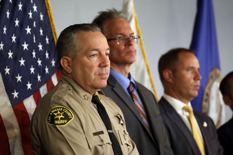 Los Angeles County Sheriff Alex Villanueva listens as Orange County District Attorney Todd Spitzer announces charges against two suspects in the 7-Eleven crime spree at the Orange County District Attorney's Office in Santa Ana, California on July 18, 2022.