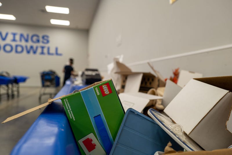 Items sit in containers as people sift through used clothes and other items at a Goodwill Outlet Center on July 27, 2022 in Hackensack, New Jersey.