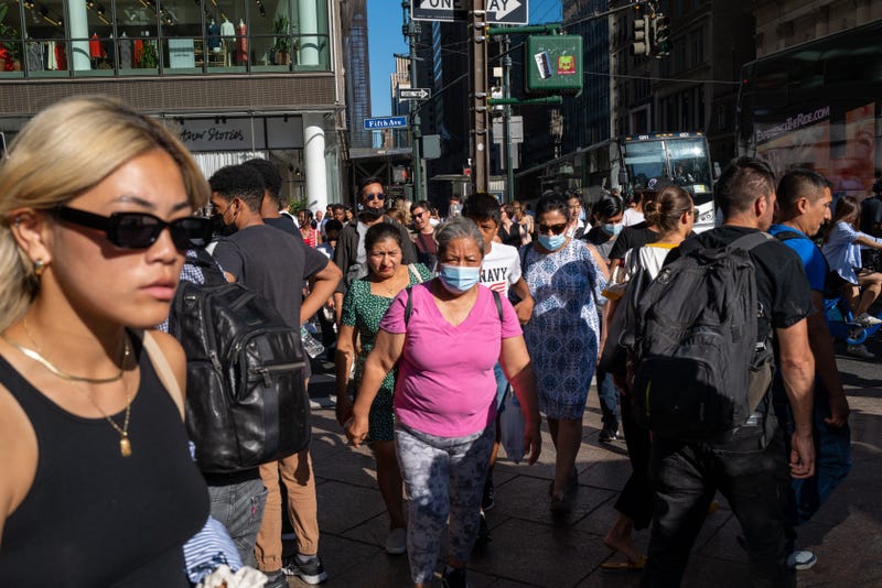 People walk through midtown Manhattan on Aug. 3, 2022