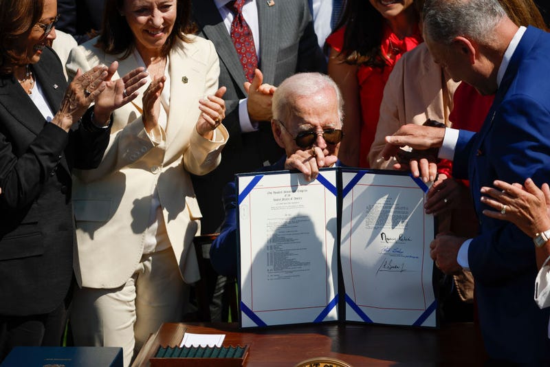 U.S. President Joe Biden holds up the bill after signing the CHIPS and Science Act of 2022 during a ceremony on the South Lawn of the White House on August 9, 2022 in Washington, D.C.