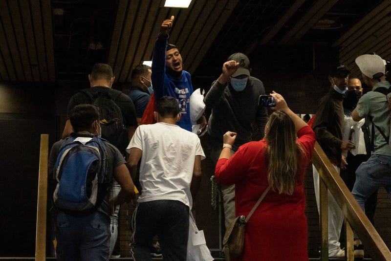 A group of migrants reacts after arriving at Port Authority Bus Terminal from Texas on Aug. 10, 2022