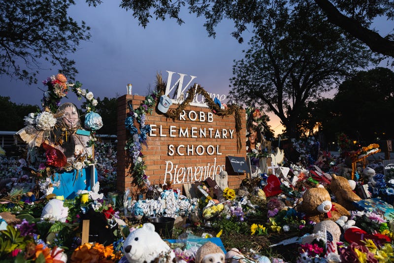 The sun sets behind the memorial for the victims of the massacre at Robb Elementary School on Aug. 24, 2022 in Uvalde, Texas.