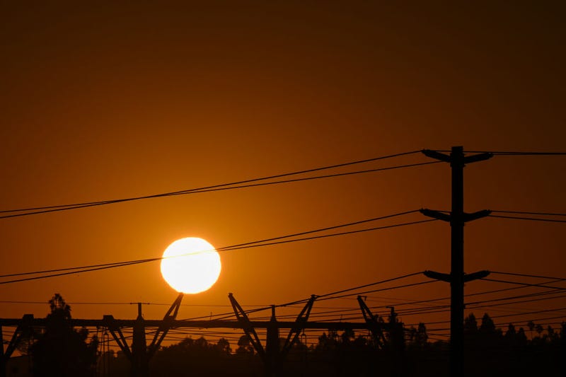 The sun sets behind electric power lines as the California Independent System Operator announced a statewide electricity Flex Alert urging conservation to avoid blackouts in Redondo Beach, California on August 31, 2022.