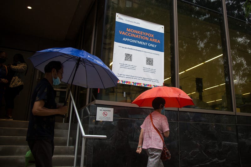 Pedestrians pass a monkeypox vaccination site in New York.
