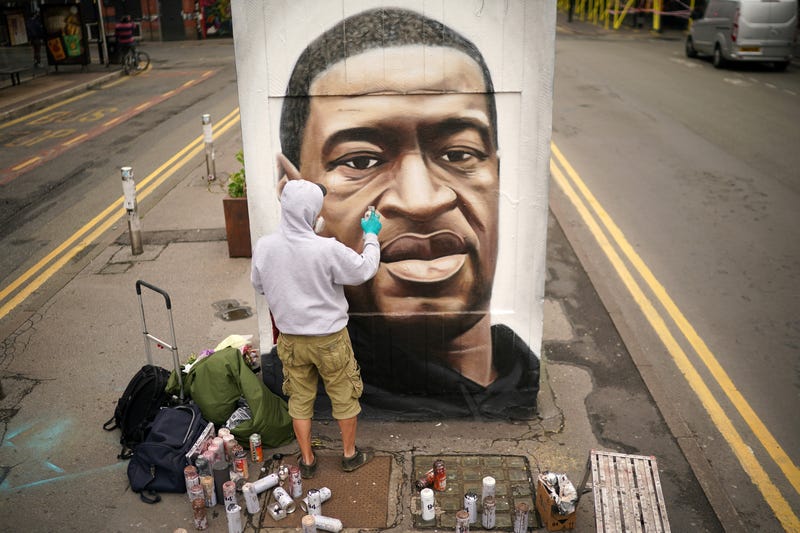 Graffiti artist Akse spray paints a mural of George Floyd in Manchester's northern quarter on June 03, 2020 in Manchester, United Kingdom.