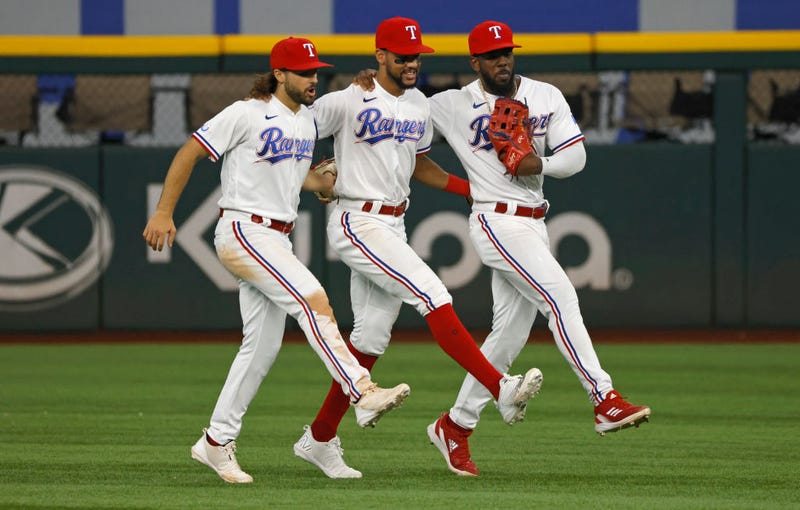 osh Smith #47 of the Texas Rangers, Leody Taveras #3 and Adolis Garcia #53 celebrate the teams 5-3 win over the Los Angeles Angels at Globe Life Field on September 22, 2022 in Arlington, Texas.