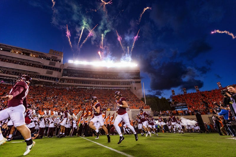 Virginia Tech players run onto the field prior to their 2022 matchup with West Virginia.