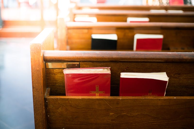 Bible's sitting in a church pew.