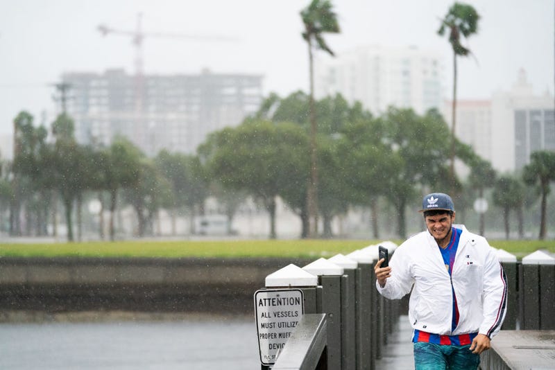 A man grimaces at the wind and rain after taking a look at Sarasota Bay as Hurricane Ian approaches on September 28, 2022 in Sarasota, Florida. Forecasts call for the storm to make landfall in the area on Wednesday as a likely Category 4 hurricane. (Photo by Sean Rayford/Getty Images)