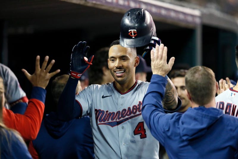 Carlos Correa #4 of the Minnesota Twins celebrates with teammates in the dugout after hitting a two-run home run against the Detroit Tigers during the seventh inning at Comerica Park on September 30, 2022, in Detroit, Michigan.