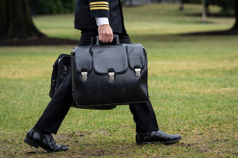 A military aide carries the "nuclear football," which contains launch codes for nuclear weapons, while walking to Marine One on the South Lawn of the White House on Oct. 3, 2022, in Washington, D.C.