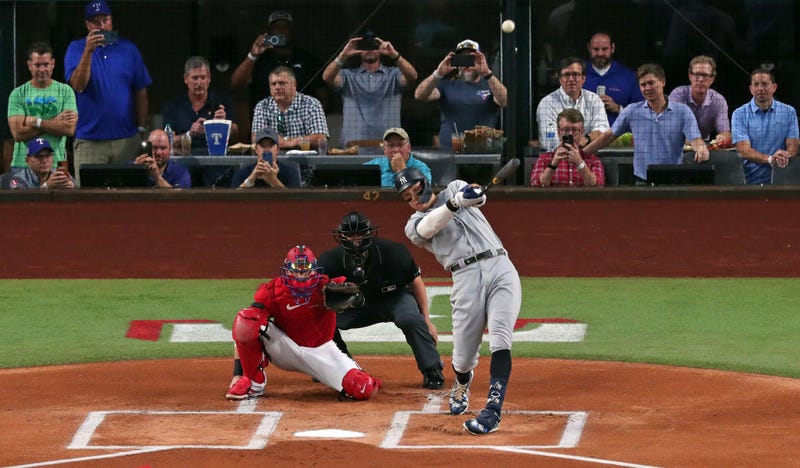 Aaron Judge #99 of the New York Yankees hits his 62nd home run of the season against the Texas Rangers during the first inning in game two of a double header at Globe Life Field on October 4, 2022 in Arlington, Texas. Judge has now set the American League record for home runs in a single season.