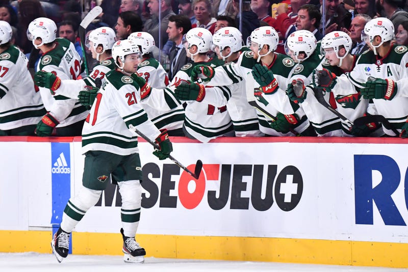 Brandon Duhaime #21 of the Minnesota Wild celebrates his goal with teammates on the bench during the second period against the Montreal Canadiens at Centre Bell on October 25, 2022 in Montreal, Quebec, Canada.