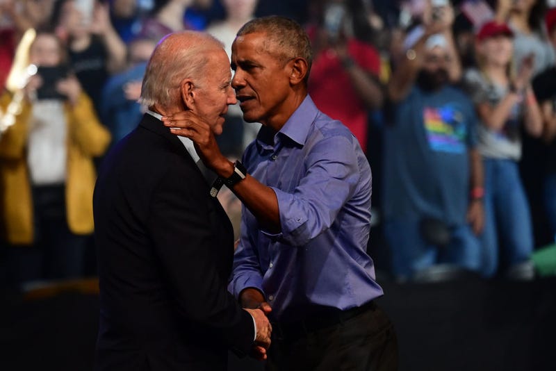 President Joe Biden (L) and former U.S. President Barack Obama (R) embrace on stage during a rally on November 5, 2022.
