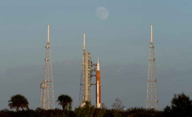 CAPE CANAVERAL, FL - NOVEMBER 06: The Moon rises behind NASAs Space Launch System (SLS) rocket with the Orion spacecraft aboard atop the mobile launcher at Launch Pad 39B as preparations for launch continue, Sunday, Nov. 6, 2022, at NASAs Kennedy Space Center in Florida. NASAs Artemis I flight test is the first integrated test of the agencys deep space exploration systems: the Orion spacecraft, SLS rocket, and supporting ground systems. Launch of the uncrewed flight test is targeted for Nov. 14 at 12:07 a.m. EST.