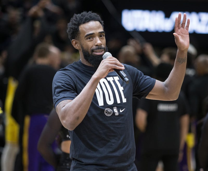Timberwolves point guard Mike Conley encourages fans to go vote during a game in 2022.