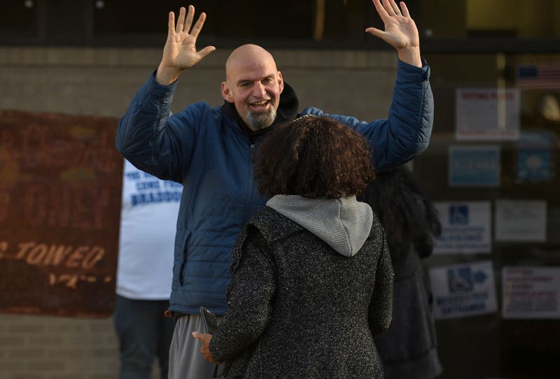 ) Pennsylvania Democratic Senate candidate John Fetterman greets a voter as he walks to his polling place to cast his vote at the New Hope Baptist Church on November 8, 2022 in Braddock, Pennsylvania.