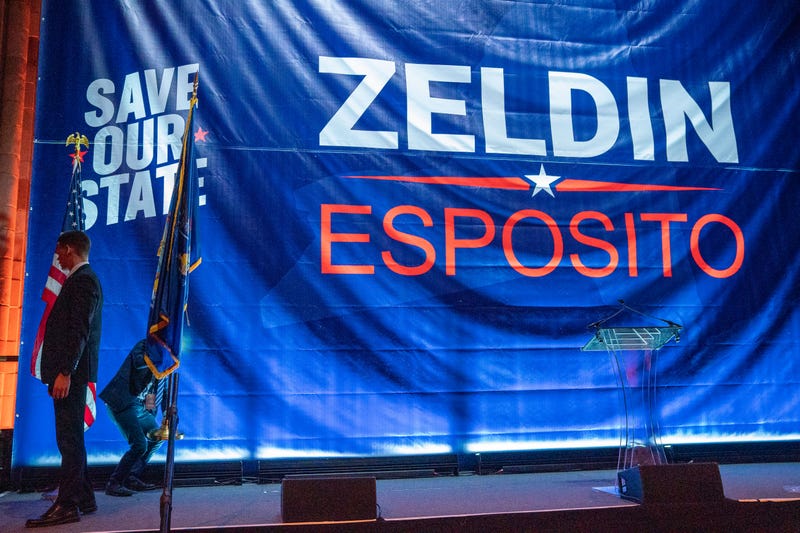 Members of Lee Zeldin's party put the final details on the campaign stage.