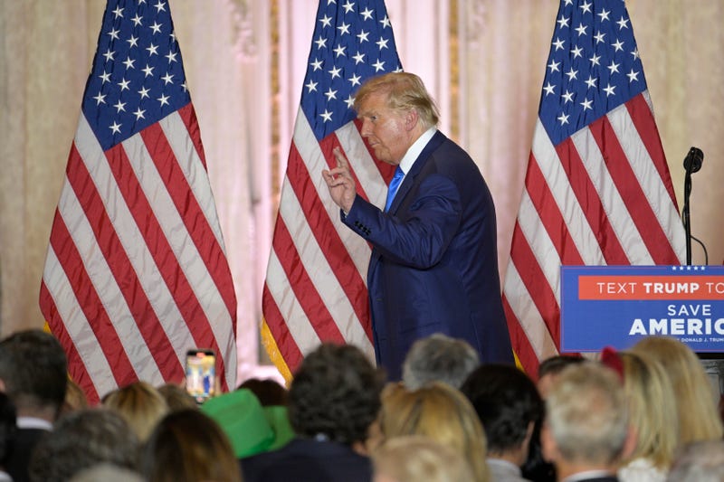 Former President Donald Trump, left, waves to guests during an election night party at Mar-a-Lago, Tuesday, November 8, 2022 in Palm Beach, Florida.