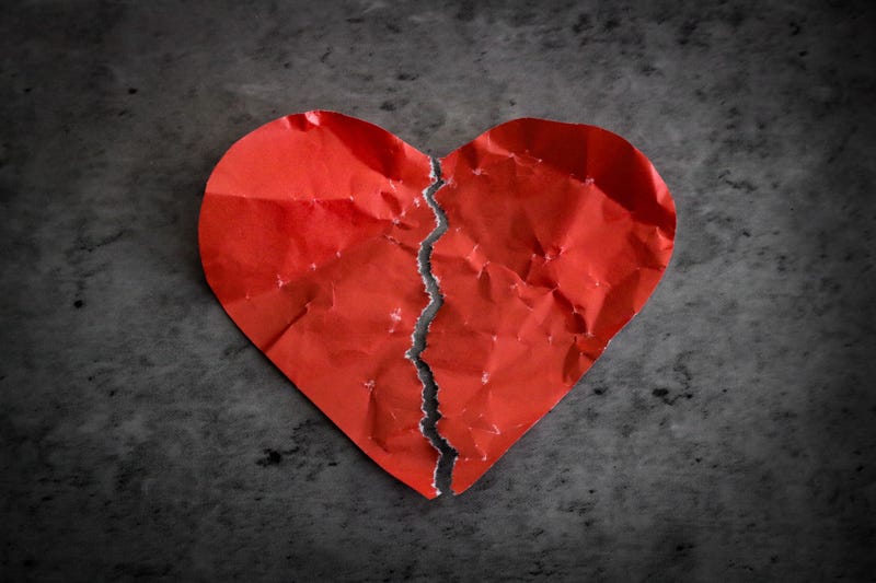 Paper heart ripped in half. 