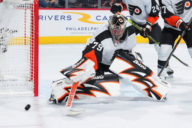 Goalie Carter Hart blocks a shot in front of the goal in Flyers uniform