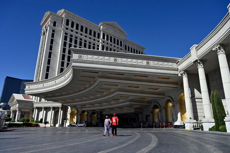 People walk from Caesars Palace on the Las Vegas Strip. 