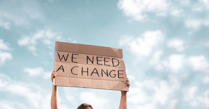 Woman holding a sign while protesting.