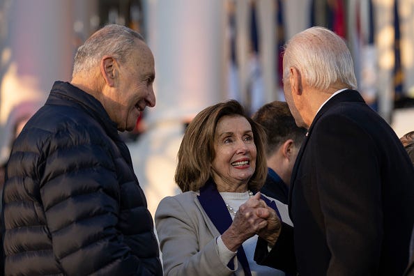 Senate Majority Leader Chuck Schumer (D-NY) looks on as Speaker of the House Nancy Pelosi (D-CA) shakes hands with U.S. President Joe Biden after he signed the Respect for Marriage Act on the South Lawn of the White House December 13, 2022 in Washington, DC. 